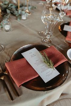 the place setting is set with silverware and napkins