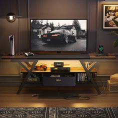 a television sitting on top of a tv stand in a living room next to a rug