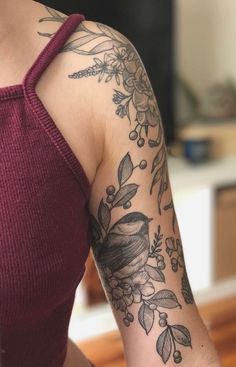 a woman with a bird tattoo on her arm