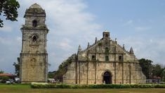 an old church with two tall towers next to it