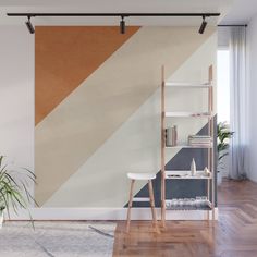 an abstract wall mural in a living room with wood flooring and white walls, along with a wooden ladder