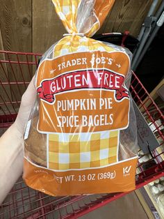 a person holding a bag of trader joe's gluten free pumpkin pie spice bags