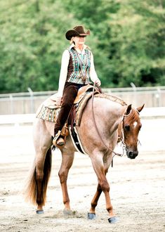 a woman riding on the back of a brown horse