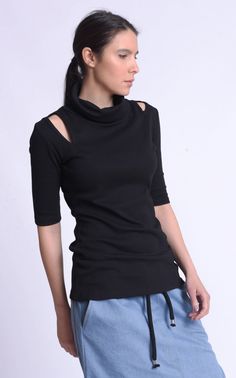 Black Casual Turtle Neck Blouse - METT0185 An unusual look and a sight to see, this handmade turtleneck top is something that will definitely bring attention to your look. The accents here are a lot and each is worth mentioning. The silhouette is tight fitting which makes this blouse look more feminine and gentle. The neck is a turtleneck and something we came to know that a lot of our customers love. The sleeves are half with elbow length. But perhaps the one that catches the eyes the most are Look More Feminine, Turtle Neck Blouse, Oversize Casual, Hooded Raincoat, Hooded Dress, Black Tunic, Turtleneck Top, Dramatic Look, Turtle Neck Top