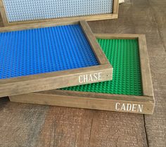 two wooden frames with legos on them that say chase and caden in white letters