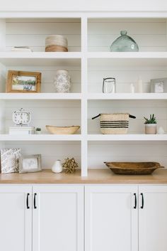 white shelves with baskets and other items on them