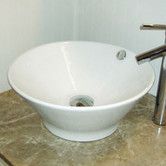 a white bowl sink sitting on top of a counter next to a faucet