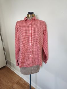 This vintage shirt is a fun addition to any wardrobe. Lands' End DIrect Merchants 55% cotton / 45% polyester The shirt features a red gingham plaid pattern. Tag size: ladies 14 Shoulder to hem length: 21.5 inches Sleeve length: 21.5 inches Chest: 42 inches The very top button is missing. This shirt is otherwise in great vintage condition with very light wear. Feel free to send me any questions! Casual Collared Gingham Shirt, Casual Gingham Collared Shirt, Preppy Cotton Shirt, Classic Plaid Shirt For Daywear, Cotton Gingham Top For Daywear, Fall Gingham Cotton Shirt, Plaid Cotton Collared Blouse, Preppy Cotton Tops For Daywear, Gingham Cotton Shirt For Work