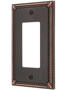 an antique style light switch plate with beading on the front and back plates in bronze