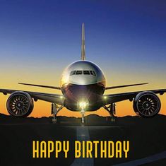 an airplane with the words happy birthday written on it is sitting on a runway at sunset