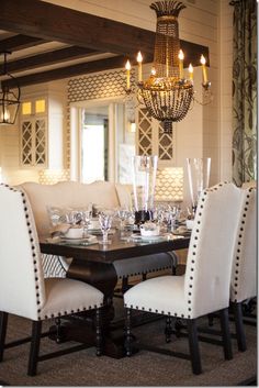 a dining room table with chairs and a chandelier