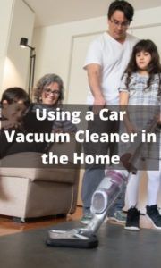 a man is using a vacuum cleaner in the living room with two children and an adult