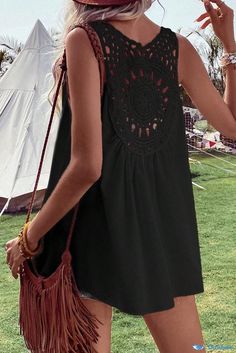 a woman in a black dress is holding a brown purse and wearing a red hat