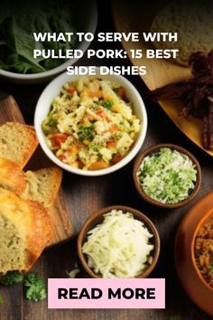 a table topped with bowls filled with food next to bread and other foods on top of it