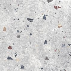 a white marble floor with small pieces of glass on it