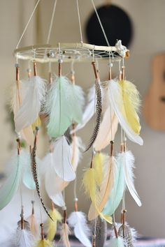 Your little one is sure to have some big dreams while sleeping under this dreamcatcher mobile. This dreamer has fluffy feathers in mint, antique gold, peach, white, and natural feathers with a mix of neutral beads to complement the overall aesthetic. This dreamer is made with a shaved willow harvested and hand shaped from my home. If you have a certain color scheme in mind, please don't hesitate to send me a direct message for a custom order. We have a stock of feathers, strings, and beads in a large variety of colors just waiting to be put to use - at no additional cost! Be sure to use the zoom feature when viewing images on etsy so you can really see the details. ** Photographers, message me for a discount in exchange for snaps of your purchased item. Dimensions: The hoop has an ~8 inch Dreamcatcher Mobile, Dream Catcher Mobile, Beautiful Dream Catchers, Feather Wall Hanging, Feather Dream Catcher, Handmade Dreamcatcher, Feather Wall, Gender Neutral Nursery, Perfect Baby Shower Gift