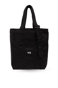 Black shopper bag from Y-3 Yohji Yamamoto. Made from fabric, this item showcases an embroidered white logo on the front, two adjustable straps and one internal compartment with a zip pocket. Composition: 100% Fabric | Y-3 Men's Shopper Bag With Logo in Black | SS24 Modern Bag With Logo Strap And Double Handle, Nylon Logo Bags For Daily Use, Nylon Bags With Logo For Daily Use, Functional Everyday Shoulder Bag With Logo, Canvas Bags With Logo Strap For Travel, Everyday Bags With Logo Strap And Double Handle, Canvas Travel Bag With Logo Strap, Travel Canvas Bag With Logo Strap, Logo Nylon Shoulder Bag For Everyday Use