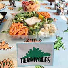 a table topped with lots of different types of vegetables and dips on top of it