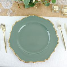 a place setting with silverware and flowers on the table cloth, ready to be served