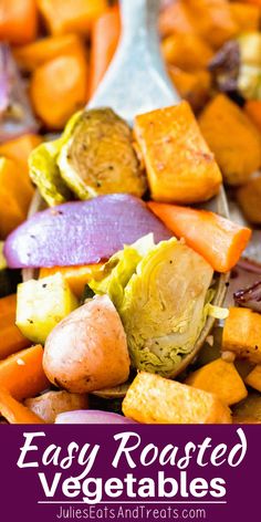 carrots, cabbage and other vegetables are mixed together in a bowl with a spoon