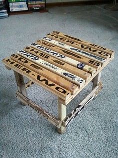 four wooden pallets stacked on top of each other in the middle of a room