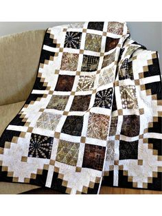 a black and white quilt sitting on top of a couch