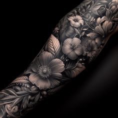 a black and white tattoo with flowers on it's arm, in front of a dark background