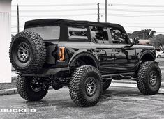 a large black truck parked in a parking lot