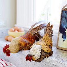 two chicken figurines are sitting on the counter