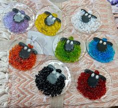 there are many beads that look like sheeps on this tablecloth, and one is made out of glass beads