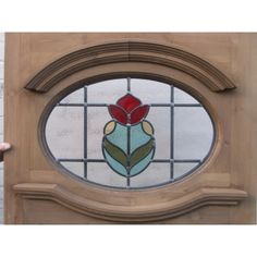 a close up of a stained glass door with a flower on it's side