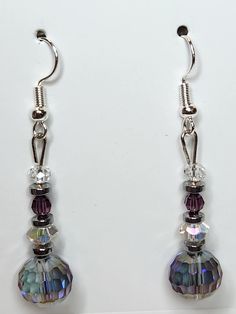 PRODUCT STYLE:     Purple Glass Dangle Earrings  DESCRIPTION: These fun dangle earrings are made of purple and clear glass beads Purple Czech Glass Earrings With Faceted Beads, Purple Faceted Bead Dangle Crystal Earrings, Purple Faceted Bead Drop Earrings, Purple Glass Dangle Earrings, Purple Crystal Earrings With Round Beads, Purple Drop Earrings With Faceted Beads, Silver Glass Drop Crystal Earrings, Purple Hypoallergenic Dangle Crystal Earrings, Glass Dangle Crystal Earrings With Ear Wire