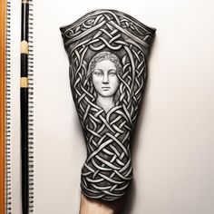 a drawing of a woman's leg with an intricate design on it and a pencil next to it