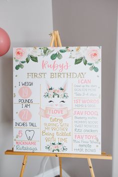 a baby's first birthday sign on an easel