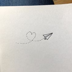 an airplane is flying in the sky with a heart drawn on it