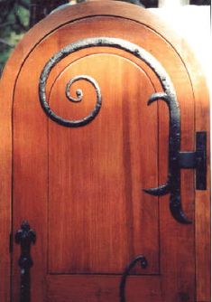 a wooden door with an iron handle on it