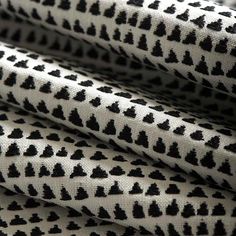 black and white patterned fabric with small hearts on it's side, close up