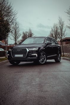 an audi suv is parked on the street