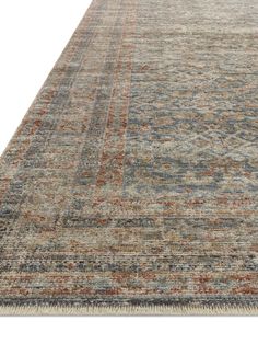 an area rug with various colors and patterns on the carpet, including blue, red, orange