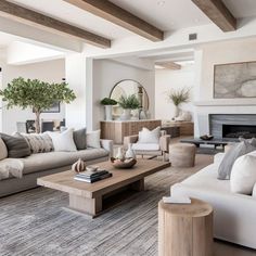 a living room filled with furniture and a fire place in the middle of a room