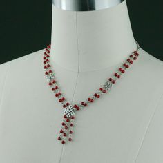 This double stand necklace is handmade using coral; Coral red, a powerful and bold color that captures the viewer's attention. One's eye will always gravitate to where the red is. The length of the necklace is 20-23 inches, or 50-58 cm. It is well suited to crew and high necklines, but can equally add a frame to a plunging neckline. This length looks great with a tailored jacket. The V-shape lariat elongates our neckline and siphones attention to our face. It is easy to wear, it is comfortable t Red Dangle Necklaces For Party, Red Beaded Necklace For Valentine's Day Gift, Red Bridal Necklace For Party, Red Long Necklace For Party, Red Necklaces For Mother's Day Party, Red Necklace For Mother's Day Party, Elegant Crystal Necklaces For Valentine's Day Jewelry Making, Mother's Day Red Party Necklaces, Red Beaded Dangle Necklace