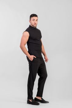 Men's sleeveless ribbed turtleneck top with raw-hem detaied sleeve holes and sewing details on the back. Color: Black Material: Ribbed Jersey (Cotton, Viscose, Elastane) -------------- SIZE GUIDE -------------- (based on body measurements) SIZE XS (US 34, UK 34, EU 44) chest: 88 cm / 34½ inch waist: 76 cm / 30 inch seat: 92 cm / 36¼ inch SIZE S (US 36, UK 36, EU 46) chest: 92 cm / 36¼ inch waist: 80 cm / 31½ inch seat: 96 cm / 37¾ inch SIZE M (US 38, UK 38, EU 48) chest: 96 cm / 37¾ inch waist: Black Turtleneck Tank Top For Spring, Black High Neck Tank Top For Layering, Black Turtleneck Sweater Vest For Layering, Black Turtleneck Tank Top For Fall, Casual Black Mock Neck Top, Casual Black Turtleneck Sweater Vest, Casual Fitted Turtleneck Tank Top, Black High Neck Cotton Top, Casual High Neck Ribbed Tank Top