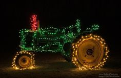 a tractor decorated with christmas lights in the dark