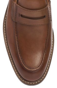 An apron toe and classic penny keeper accentuate the streamlined style of a luxe leather loafer designed with tonal stitching for timeless appeal. Leather upper/synthetic and textile lining/rubber sole Imported Classic Cognac Moc Toe Loafers, Timeless Brown Moc Toe Moccasins, Classic Cognac Moccasins With Round Toe, Classic Cognac Loafers For Business Casual, Brown Moc Toe Dress Shoes For Work, Brown Moc Toe Moccasins For Work, Masculine Workwear Moccasins With Brogue Detailing, Penny Loafers Men, An Apron