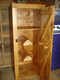 an open wooden cabinet sitting on top of a hard wood floor