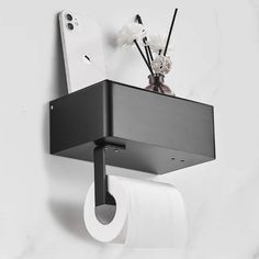 a toilet paper holder with two rolls of toilet paper hanging from it's side