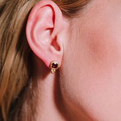 These handcrafted earrings feature a deep red garnet, elegantly set in a rich gold bezel. The delicate gold accents add a playful touch, creating a more casual feel. This piece can easily be combined with a casual oufit or really be accentuated by combining it with a red or black cocktail dress. Sterling silver   Gold vermeil   Garnet  To properly care for your silver jewellery, there are a few important steps you should follow: Clean the jewellery regularly to prevent tarnishing and discoloration. Use a mild detergent or special silver matting sponge. Gently rub the jewellery to remove dirt and oxidation. Avoid gold-plated surfaces so that they do not rub off the gold layer. Avoid contact with chemicals such as perfume, hairspray, cleaning products or chlorinated water. These substances c Red Or Black, August Birthstone Jewelry, July Birthstone Jewelry, Zodiac Jewelry, Black Cocktail, Gifts For New Mums, Pearl Jewellery Earrings, Jewelry Ring Box, Silver Jewelry Handmade