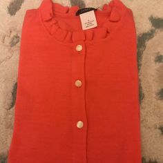 Never Worn New Without Tag Light Weight J.Crew Cardigan Sweater In Coral Size Small. 100% Merino Wool With Ruffled Details On The Collar And Extra Replacement Button Attached On Interior Of Sweater If Needed. See Pics For Details Red Spring Cardigan With Button Closure, Red Button Sweater For Spring, Red Buttoned Sweater For Spring, Trendy Red Crew Neck Cardigan, Red Button-up Cardigan For Spring, Red Buttoned Cardigan For Spring, Red Crew Neck Outerwear For Spring, Red Crew Neck Cardigan For Spring, Casual Red Cardigan For Work