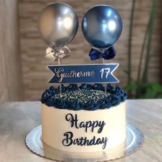 a birthday cake with two balloons on top