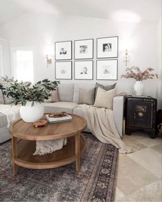 a living room filled with lots of furniture and pictures on the wall above it's coffee table